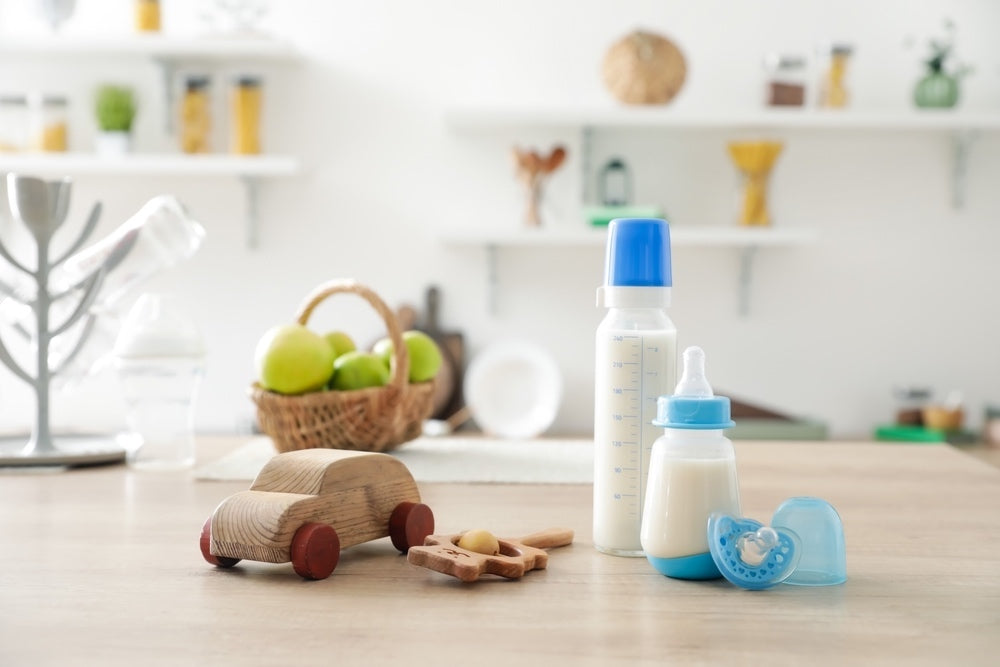 baby bottles and toys on a counter