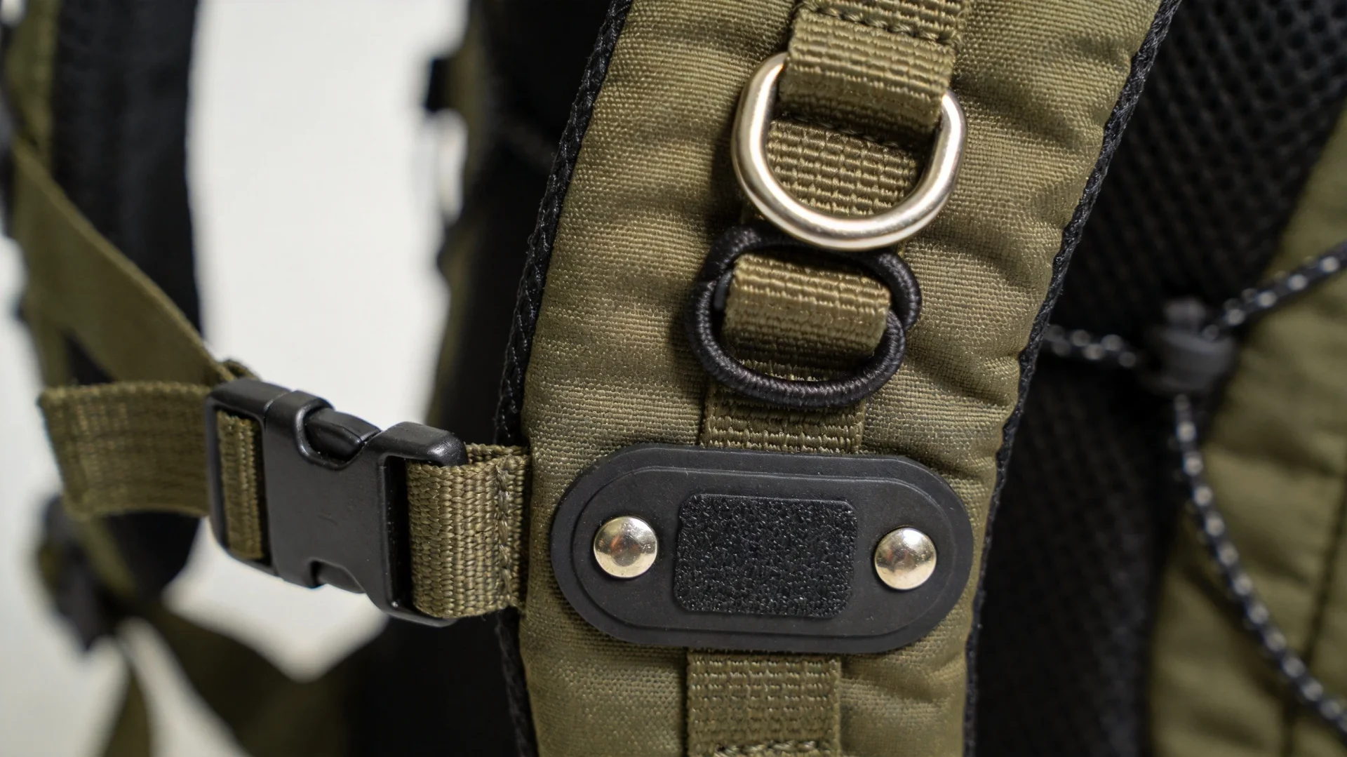 Different bungee cord attachment methods on backpacks including D-ring, webbing loops and riveted anchor points - OEM design options