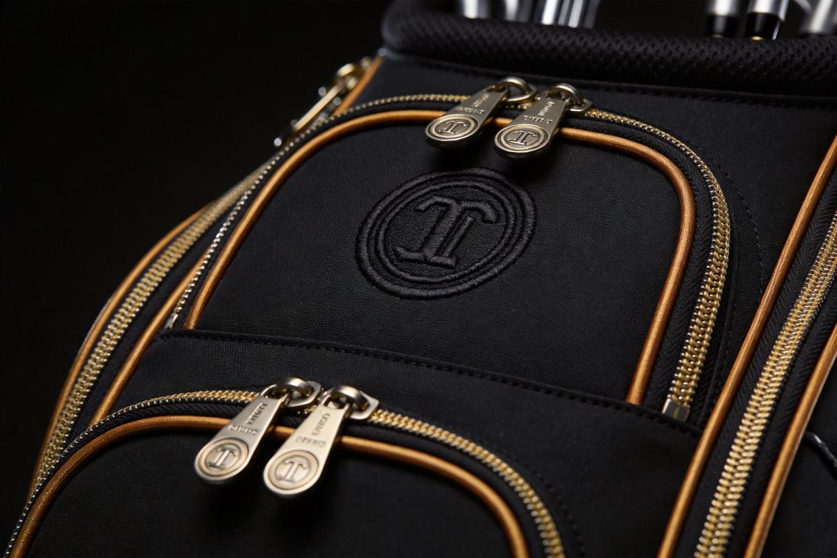 Close-up of custom branding on premium golf bags showing embroidery logo and metal hardware