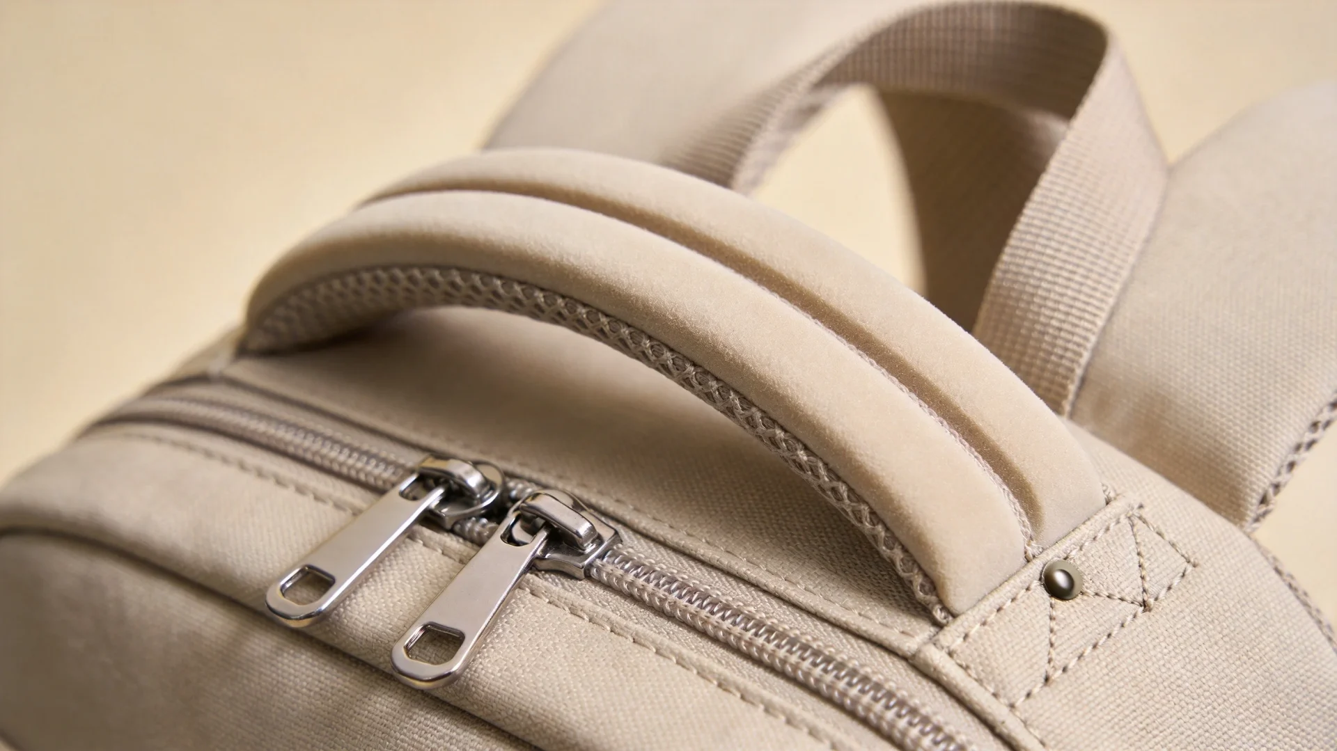 Close-up of premium backpack materials and craftsmanship - stitching quality zipper detail and fabric texture in Lululemon-style alternatives