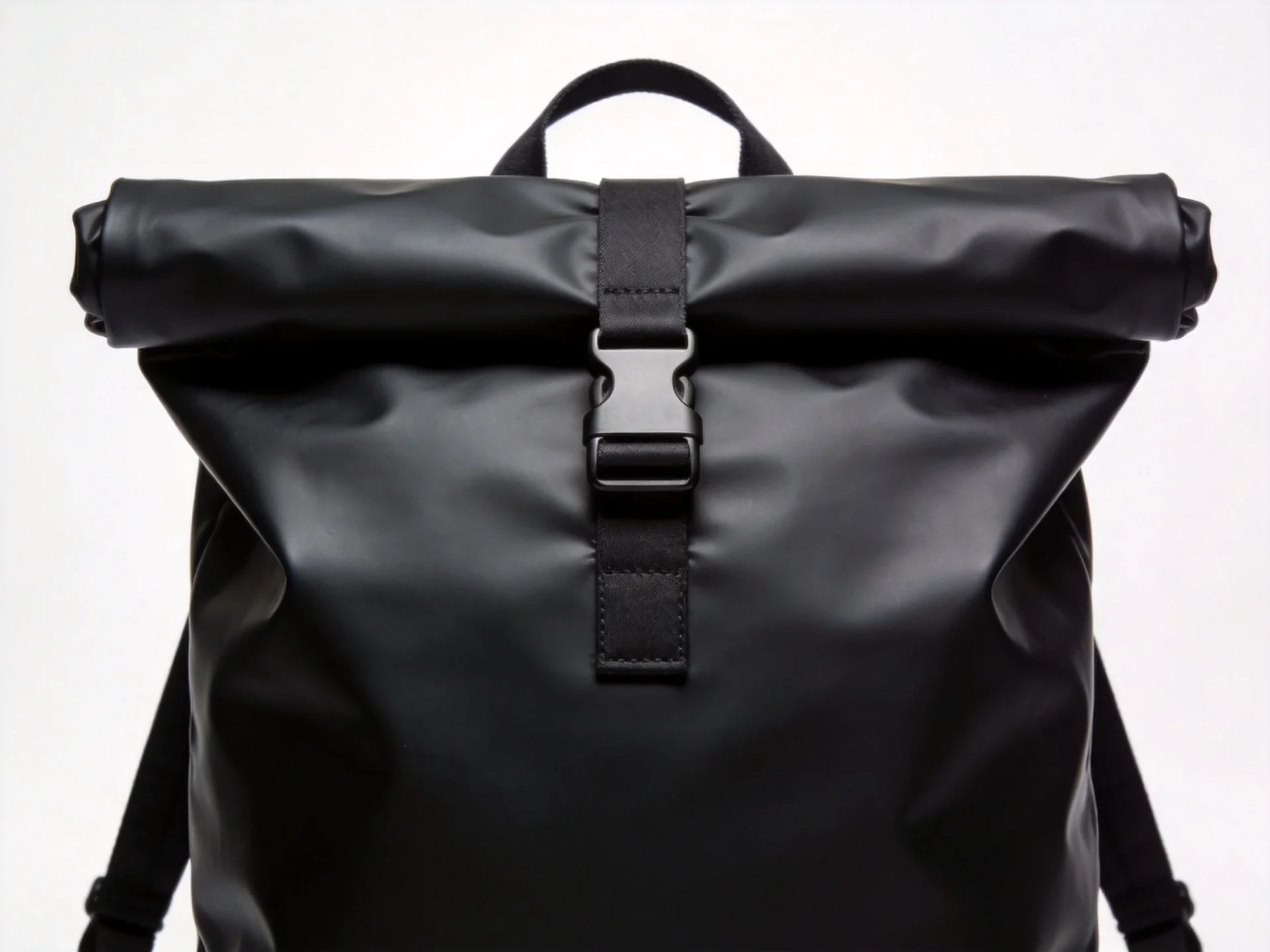 Rains style minimalist waterproof urban backpack in matte black with roll-top buckle closure