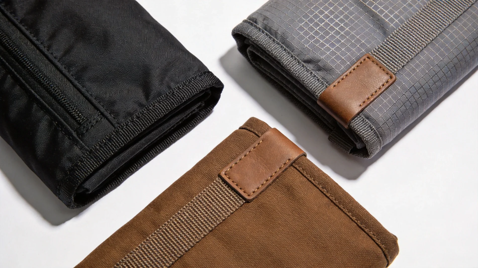 Close-up of premium 1680D ballistic nylon and Cordura fabric swatches for tool backpack manufacturing