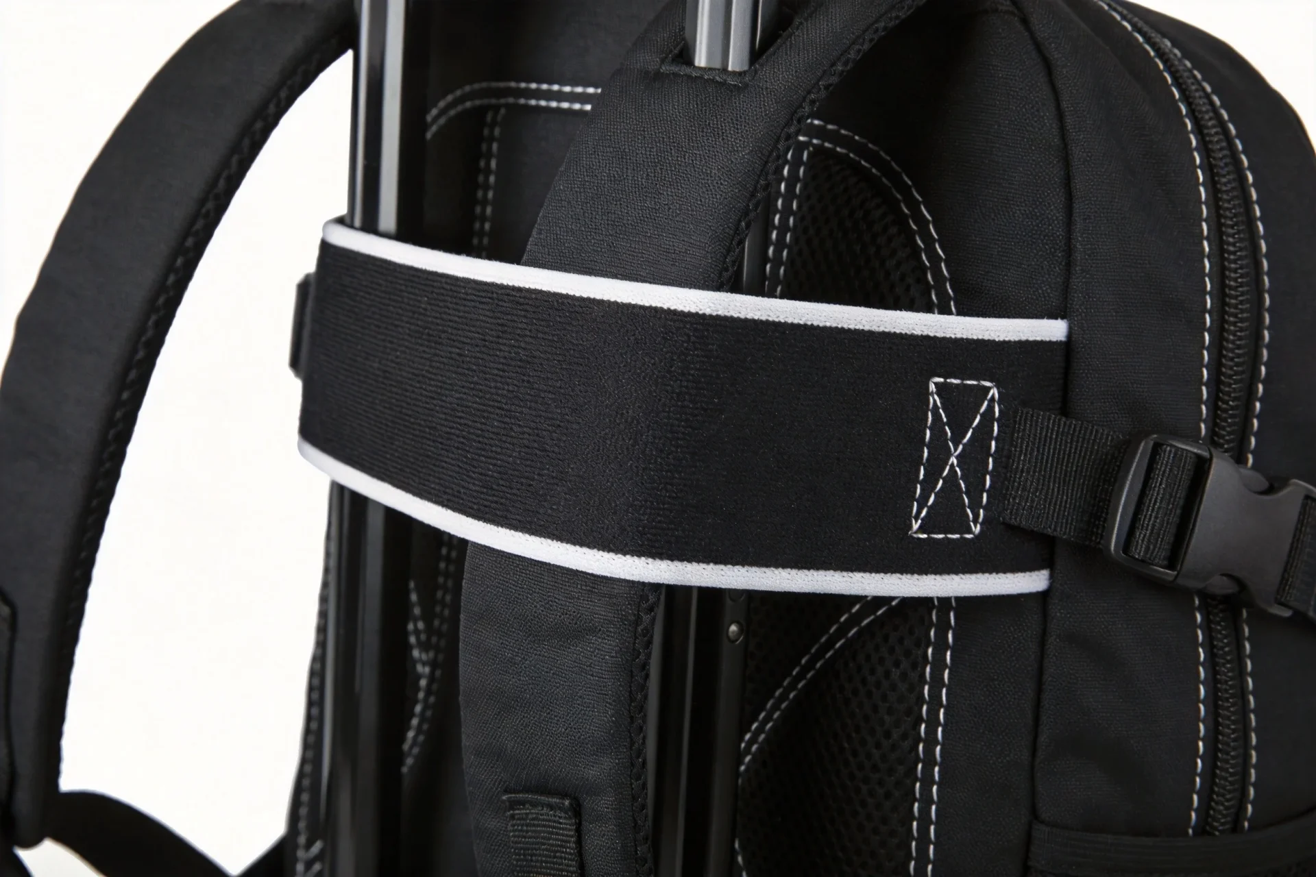 Close-up of elastic trolley sleeve strap showing reinforced bar-tack stitching on travel backpack back panel