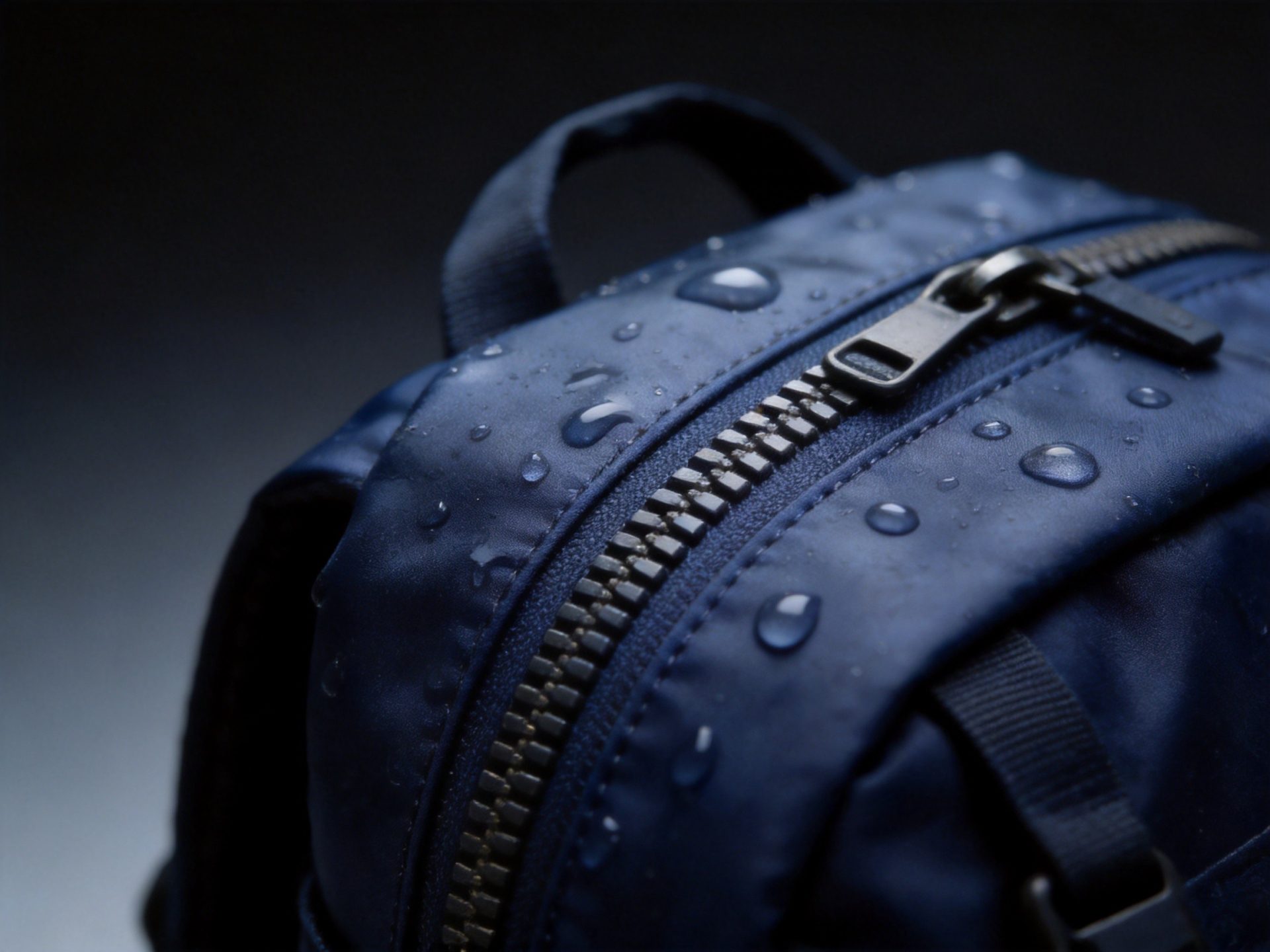 Close-up of premium waterproof zipper with water-repellent coating on backpack