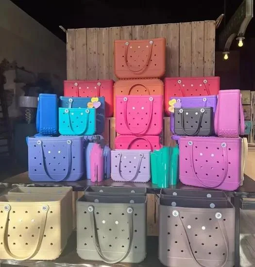 Colorful EVA molded tote bags displayed in retail setting showing the range of Bogg-style rubber beach bags