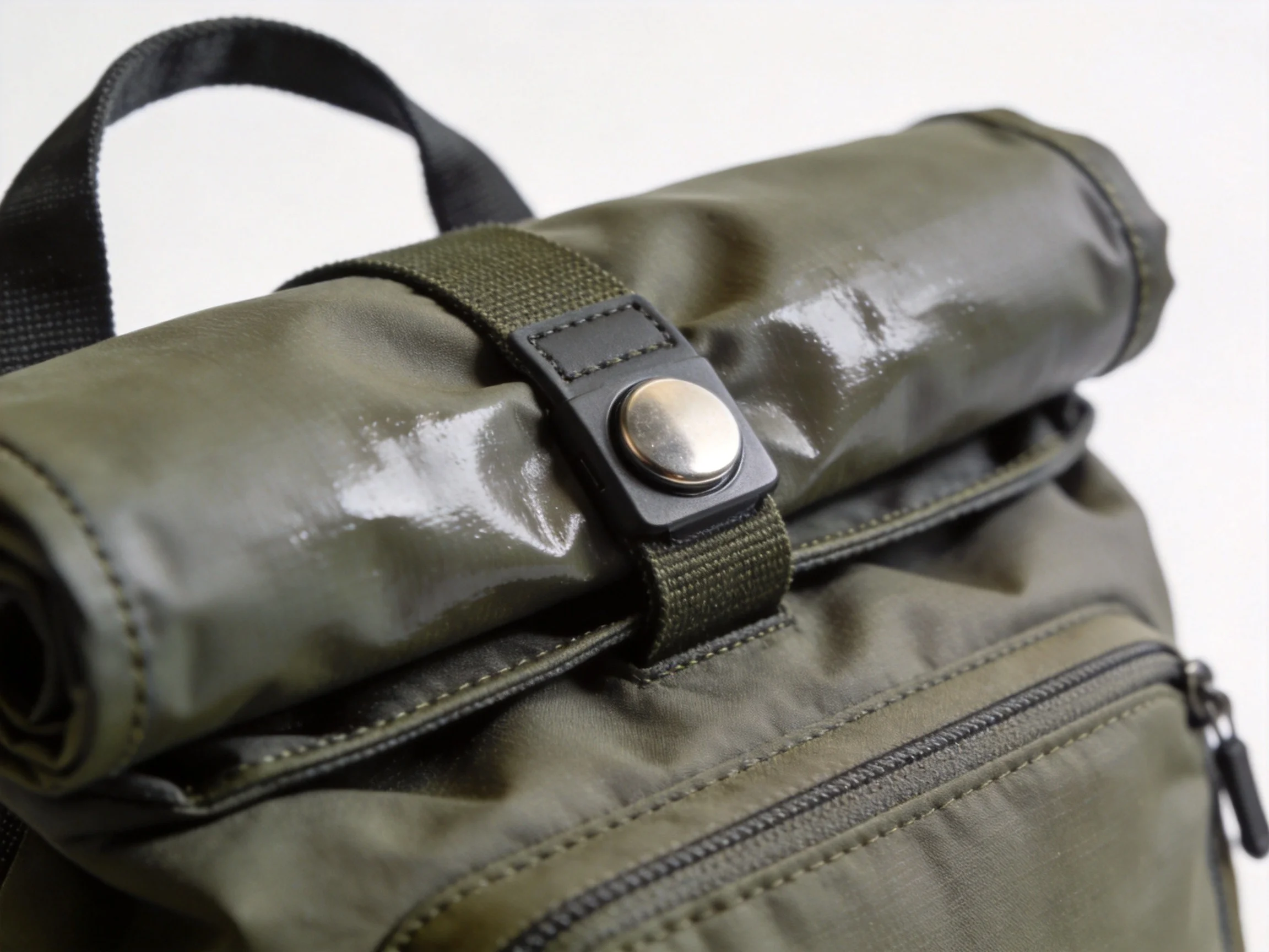 Roll-top magnetic closure detail on waterproof backpack