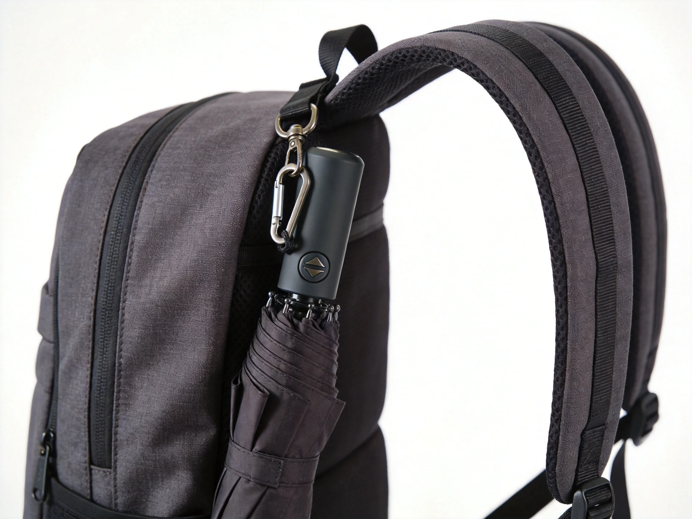 Backpack with attachable umbrella clipped to shoulder strap with carabiner